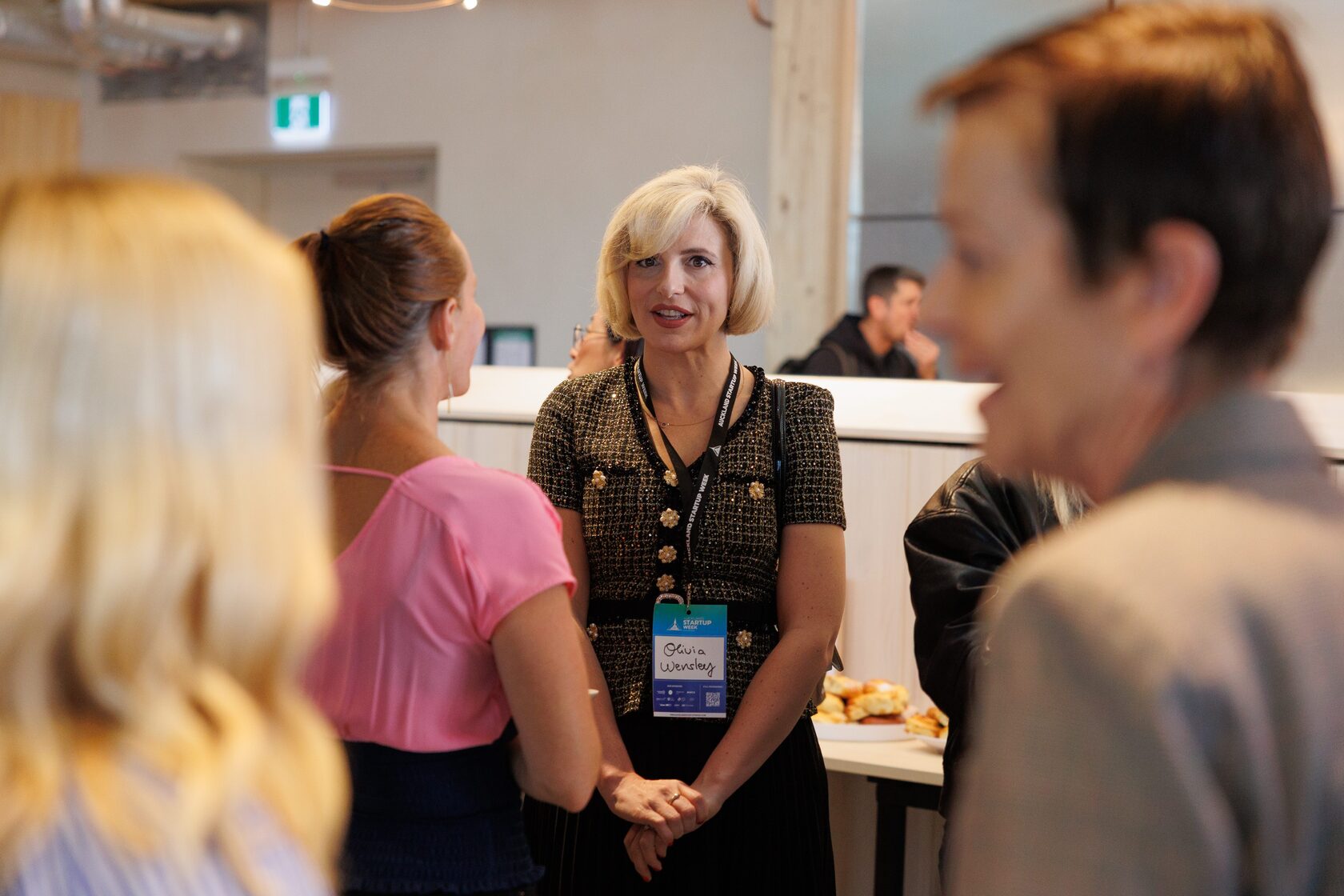 Four attendees talking beside the catering table during the morning break