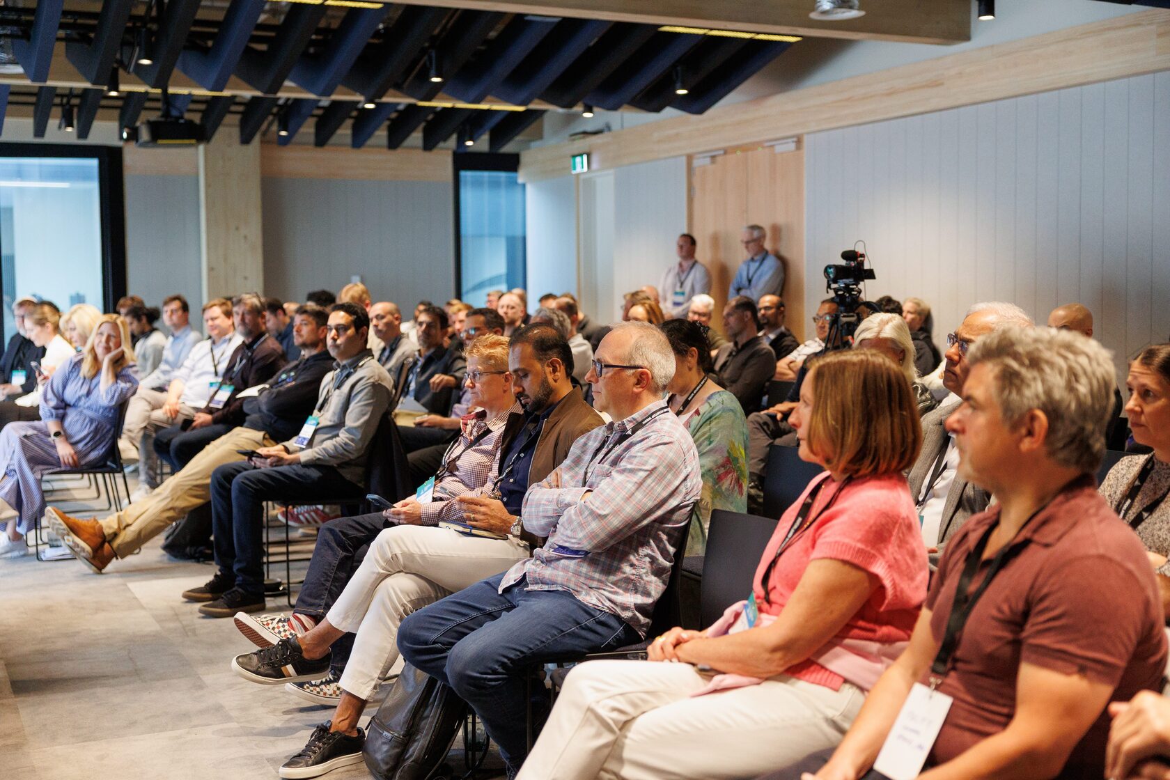 A full room of seated attendees facing the stage at NZVC Portfolio Day 2025