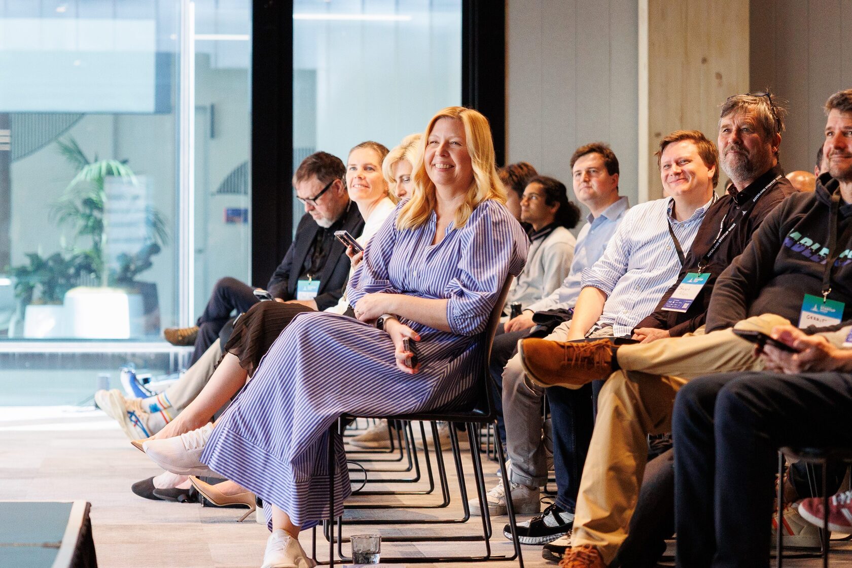 Panelists seated in a row on stage in daylight during a Portfolio Day 2025 session