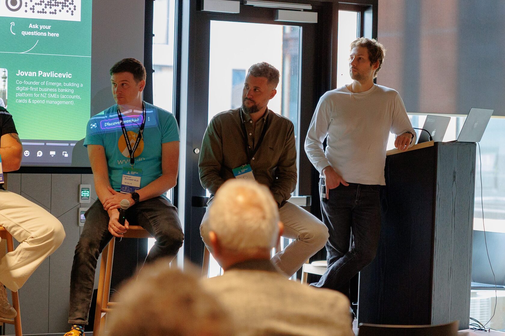 Panelists and a moderator at the lectern during the Fintech Frontiers session