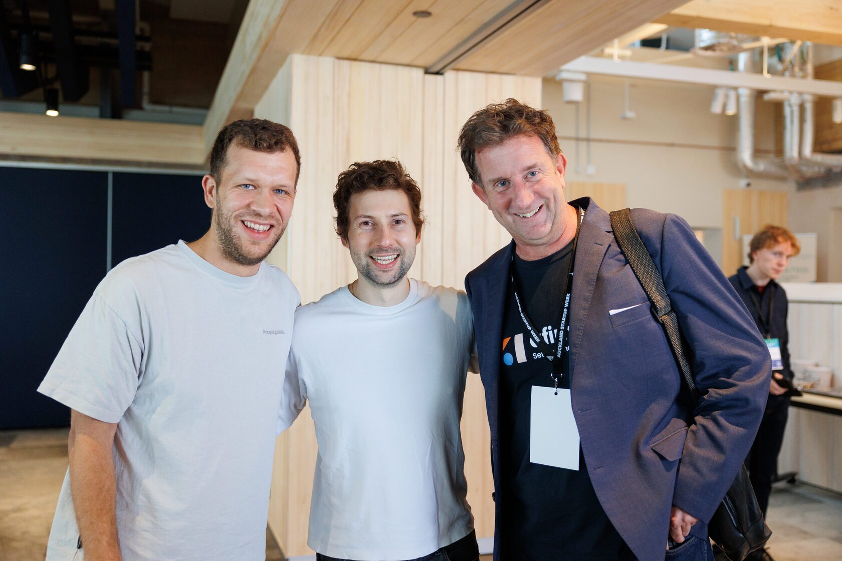 Three attendees standing together in the foyer at NZVC Portfolio Day 2025
