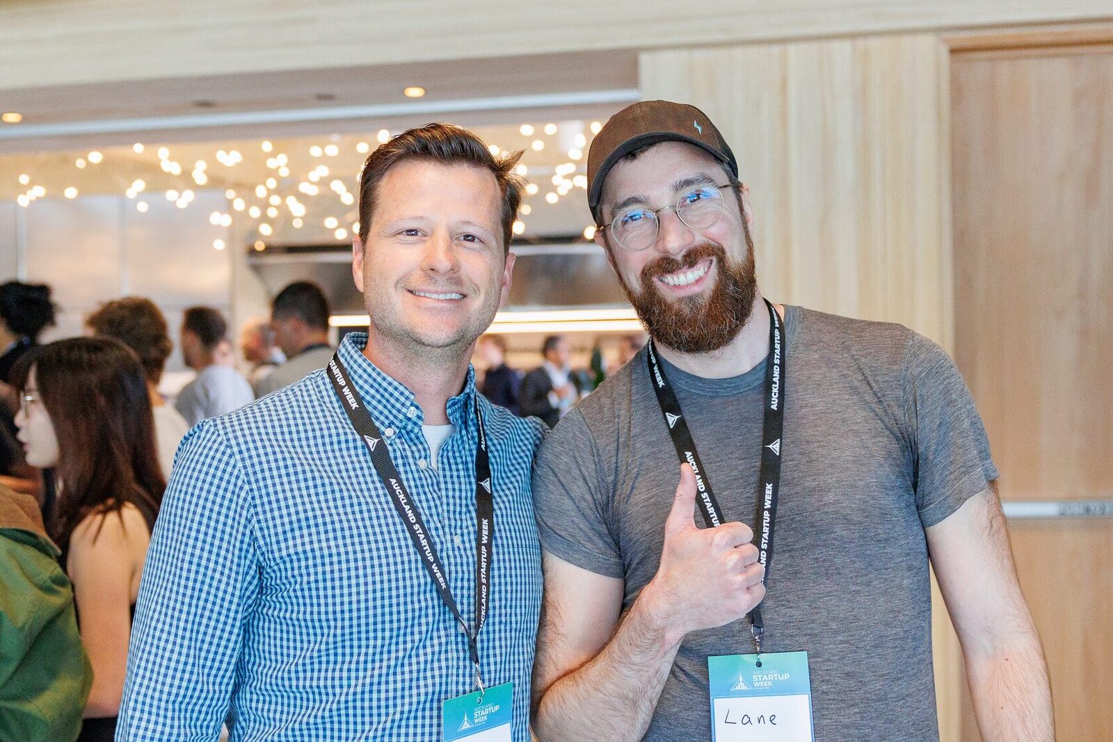 Two attendees giving a thumbs-up together during the evening drinks