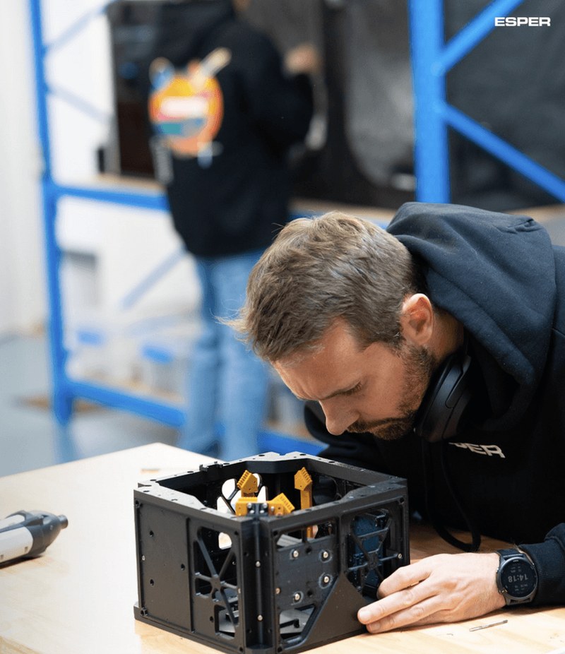 Esper: engineer assembling satellite chassis