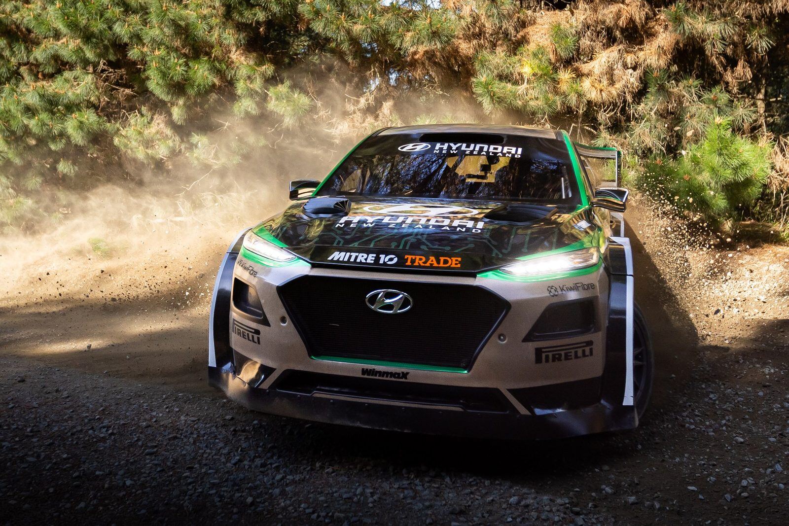 A rally car cornering on harakeke composite bodywork